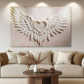 Winged heart canvas wall art with white and tan angel wings and a raised heart center.