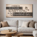 Landscape faith wall sign with beige wood grain and dark quote: “There is always something to be thankful for.”