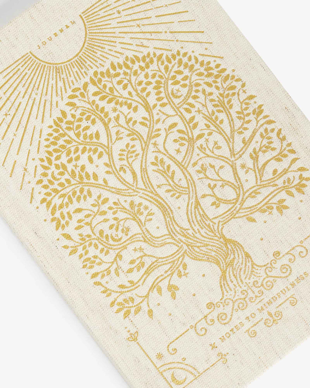Linen journal cover close-up with gold tree and sunburst line art