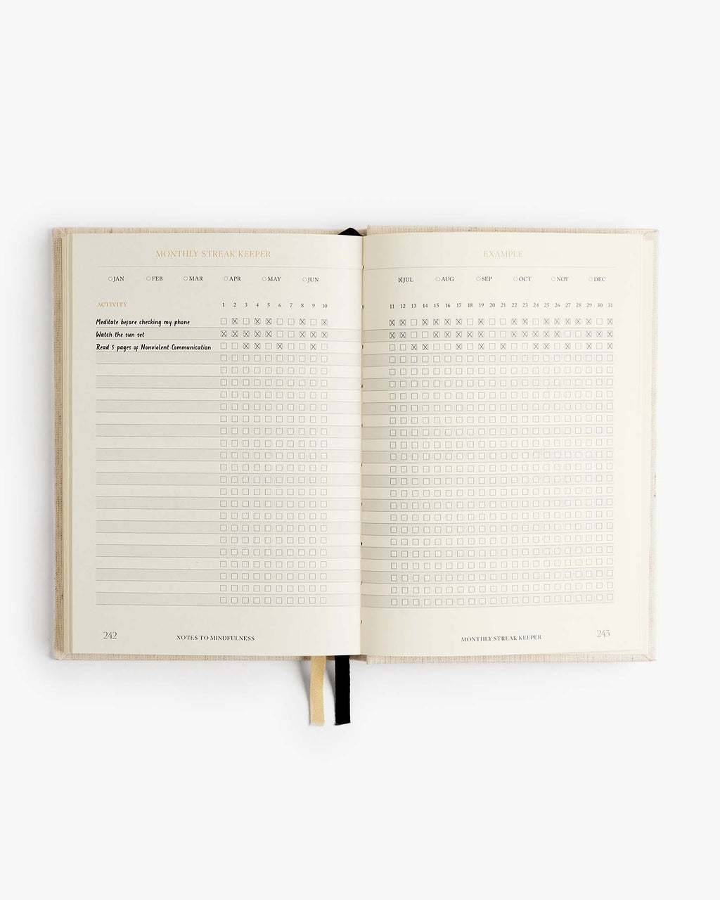 Open mindfulness journal with checklist grid blocks and lined writing areas