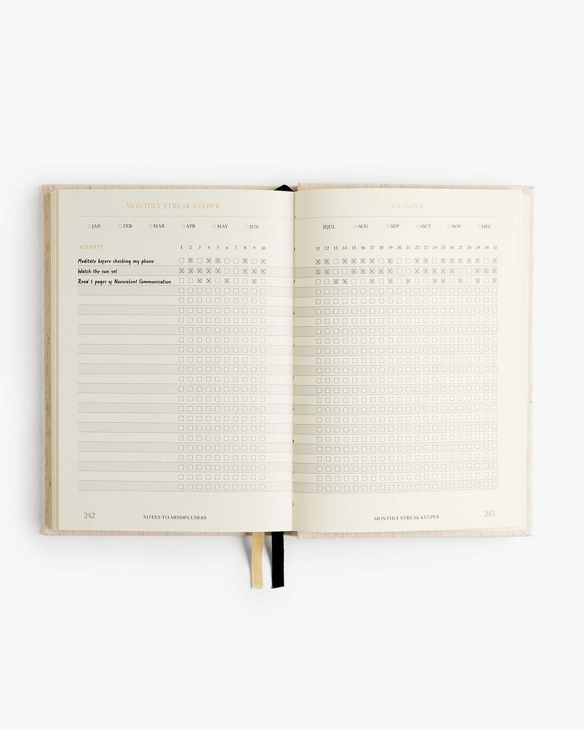 Open mindfulness journal with checklist grid blocks and lined writing areas