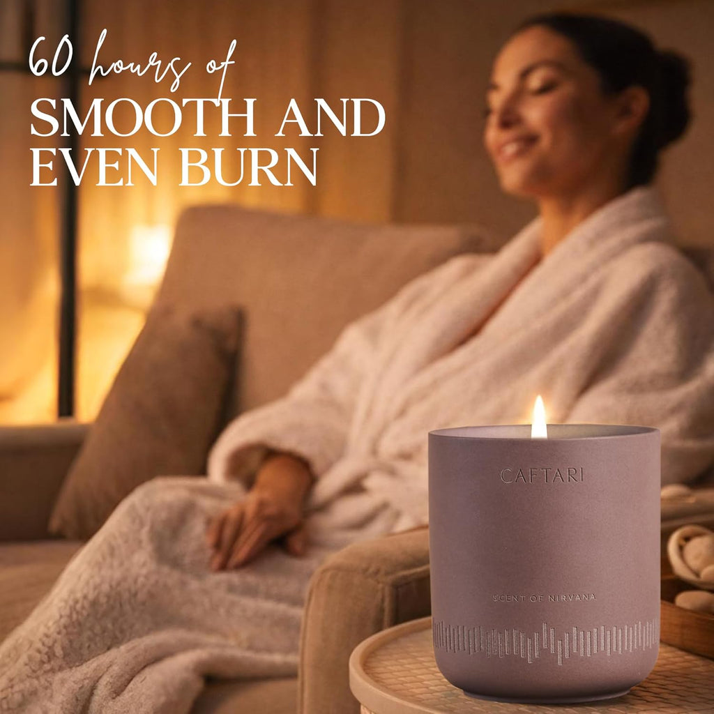 Lit purple meditation candle with CAFTARI label, smooth ceramic vessel