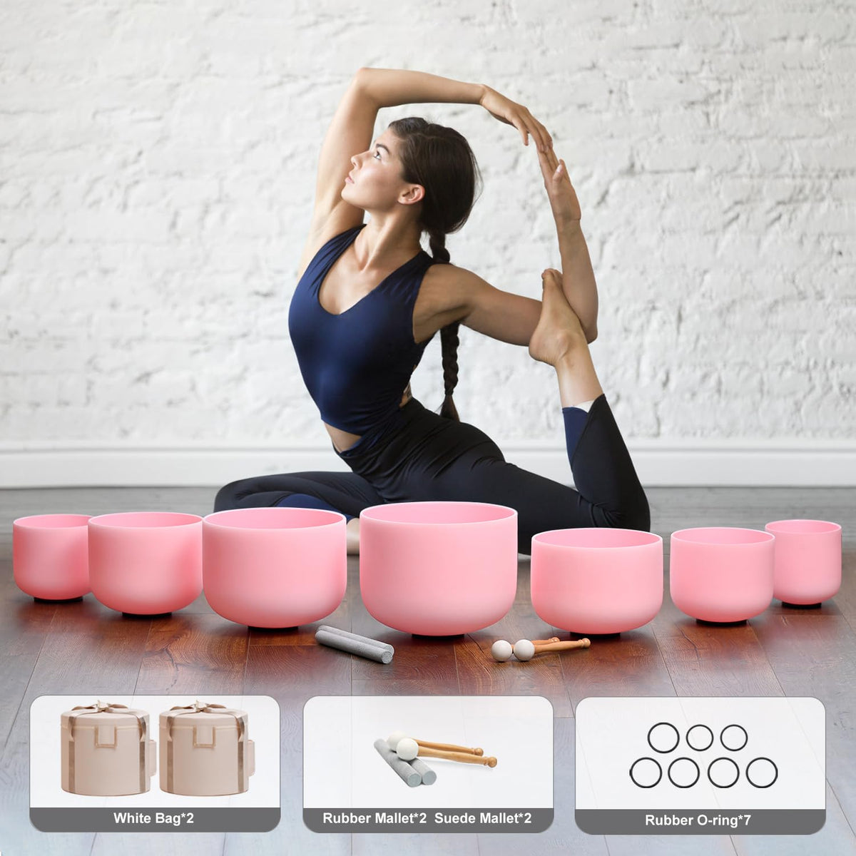 Pink frosted crystal singing bowls set with mallets and accessories arranged on floor