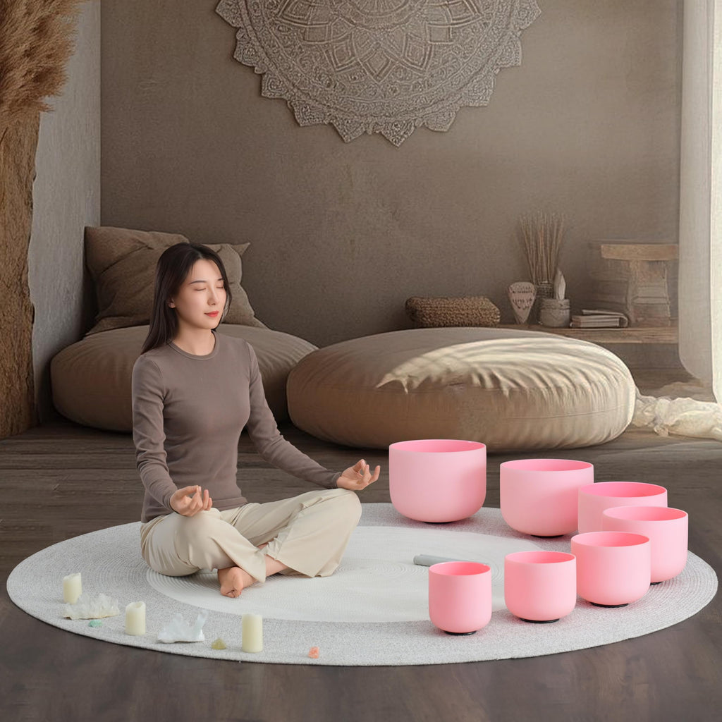 Meditation scene with pink frosted crystal singing bowls on a round rug