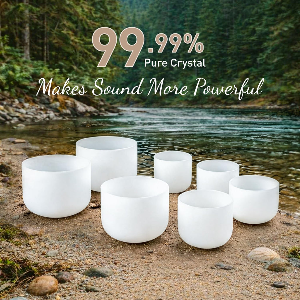 White frosted crystal singing bowls set placed on river stones