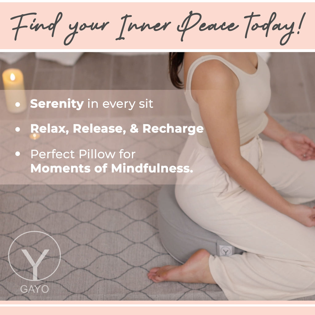 Gray round meditation cushion on a rug, supporting a seated yoga pose.