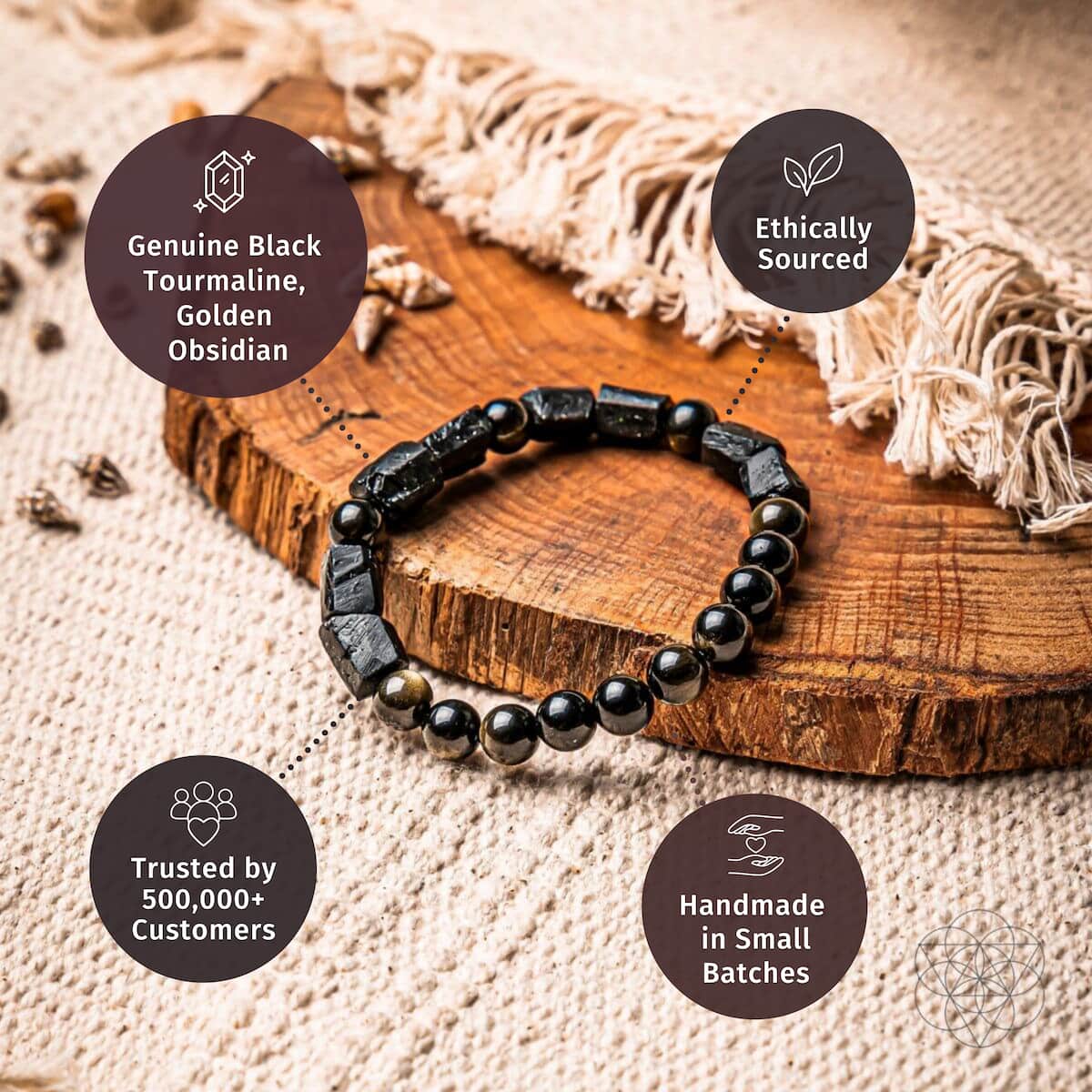Black stone and bead bracelet on wooden slab with round gold-tone accent beads