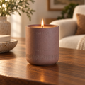 Lit purple CAFTARI meditation candle with flame in matte ceramic vessel