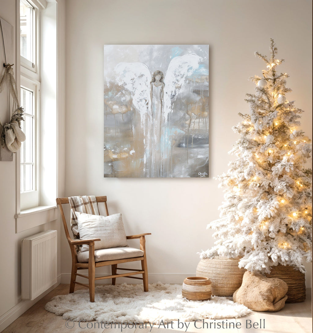 Framed angel guardian print on wall with soft blue and beige abstract artwork