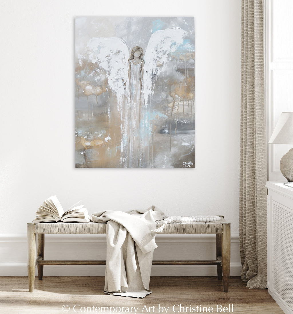 Framed angel guardian print on wall above bench, pale blue and gold abstract tones