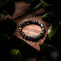 Black bead bracelet with dark rectangular stones and small gold-tone accent beads