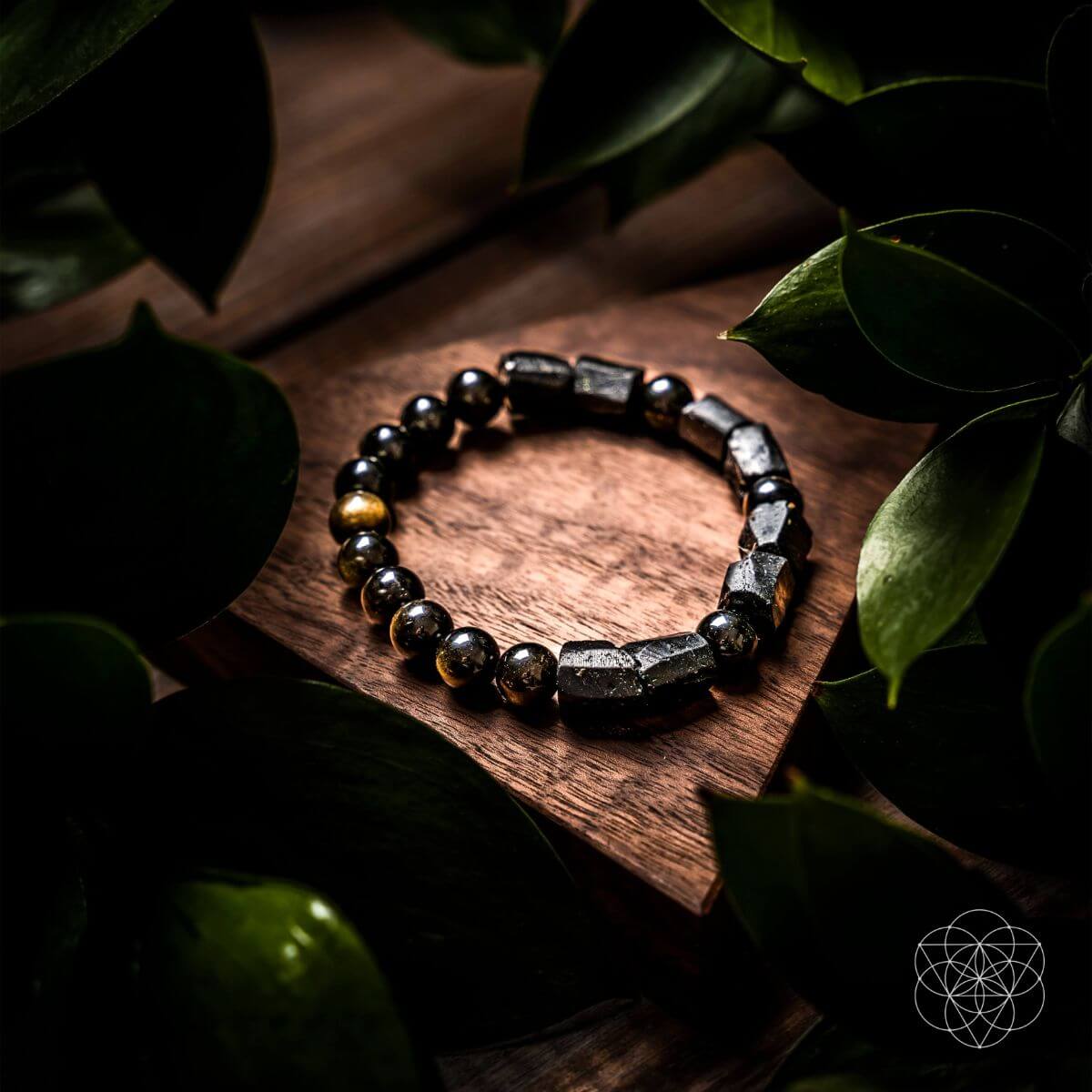 Black bead bracelet with dark rectangular stones and small gold-tone accent beads